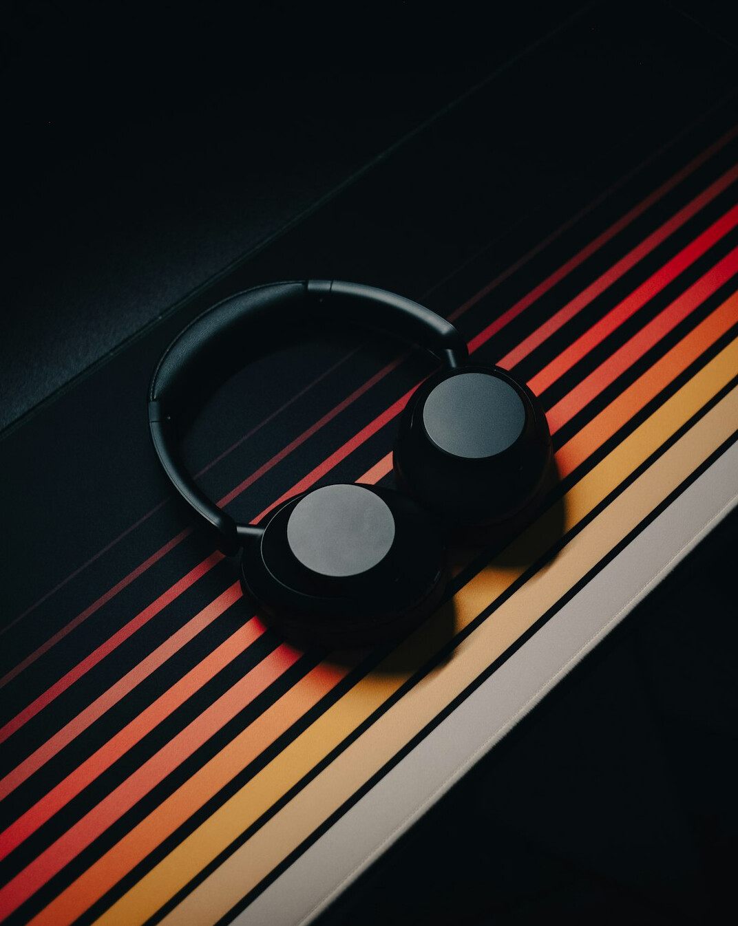 Studio headphones and audio waveform on a screen