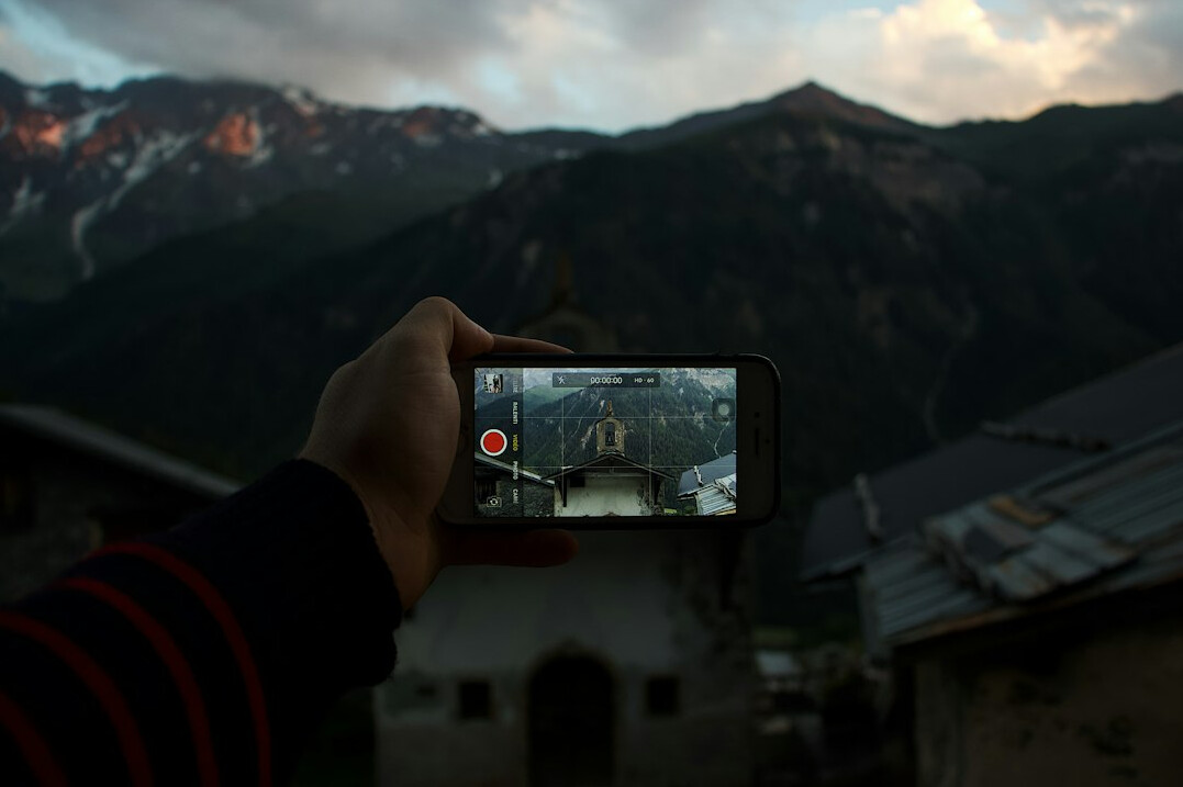 Camera on a tripod overlooking Swiss alpine lake at sunrise
